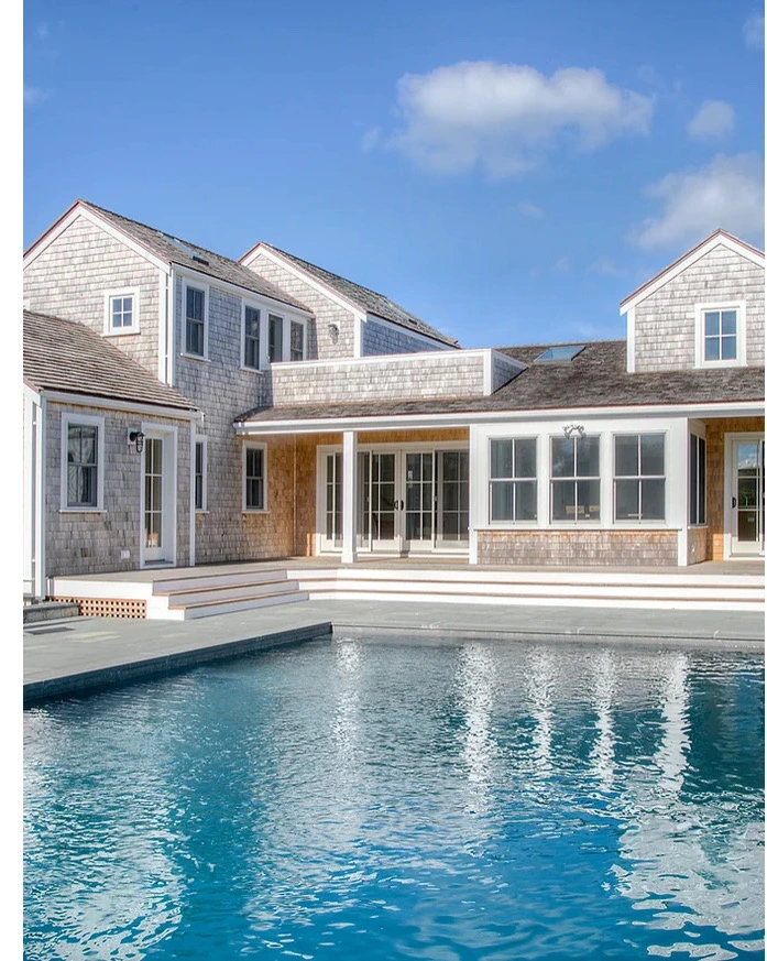 Coastal shingle-style home with pool