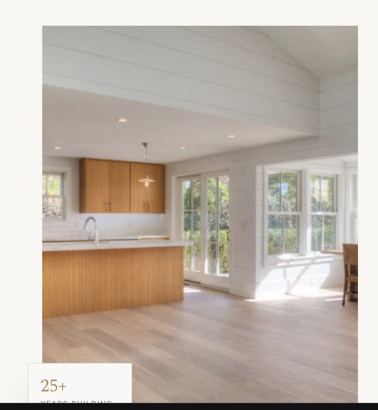 Completed kitchen with warm wood cabinets, shiplap ceiling, and white oak hardwood floors